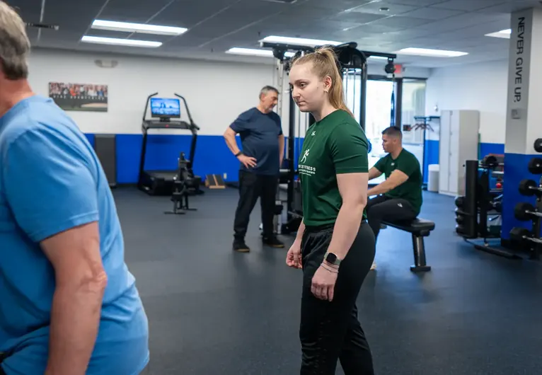 Two trainers working with clients side by side