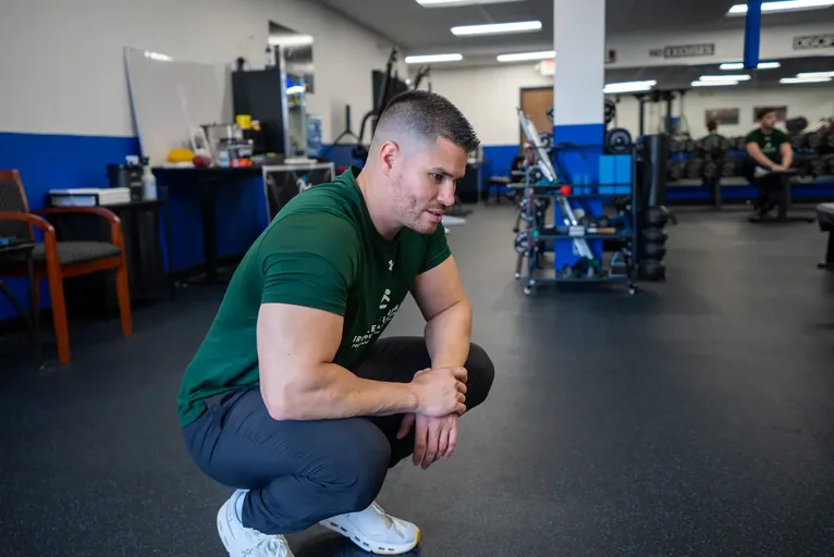 Trainer setting up equipment for a client session
